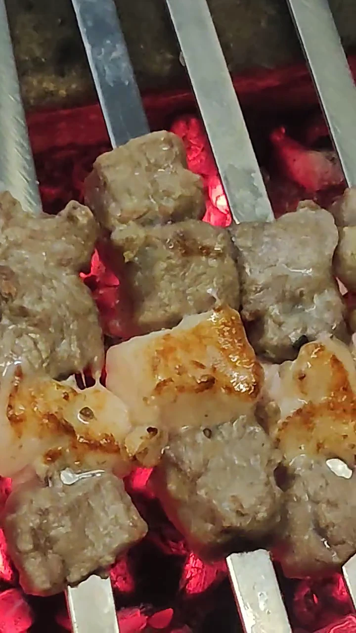 Unedited clip from their grill — mutton boti and fat on live coals.